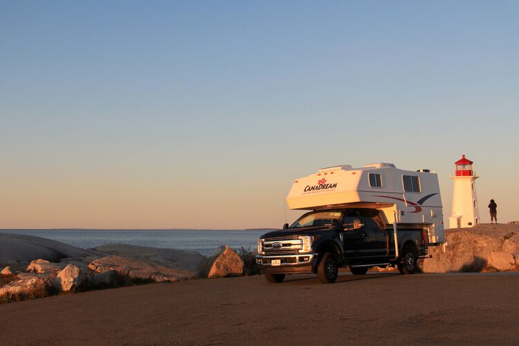 Der TCA Truck Camper von CanaDream bei Sonnenuntergang am Leuchtturm in Peggy's Cove, Nova Scotia