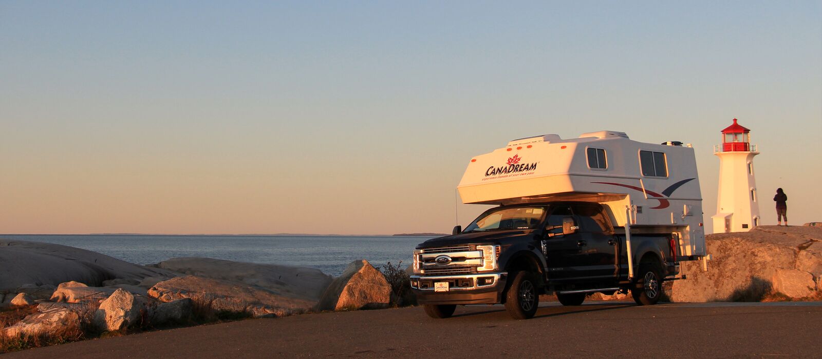 Der TCA Truck Camper von CanaDream bei Sonnenuntergang am Leuchtturm in Peggy's Cove, Nova Scotia