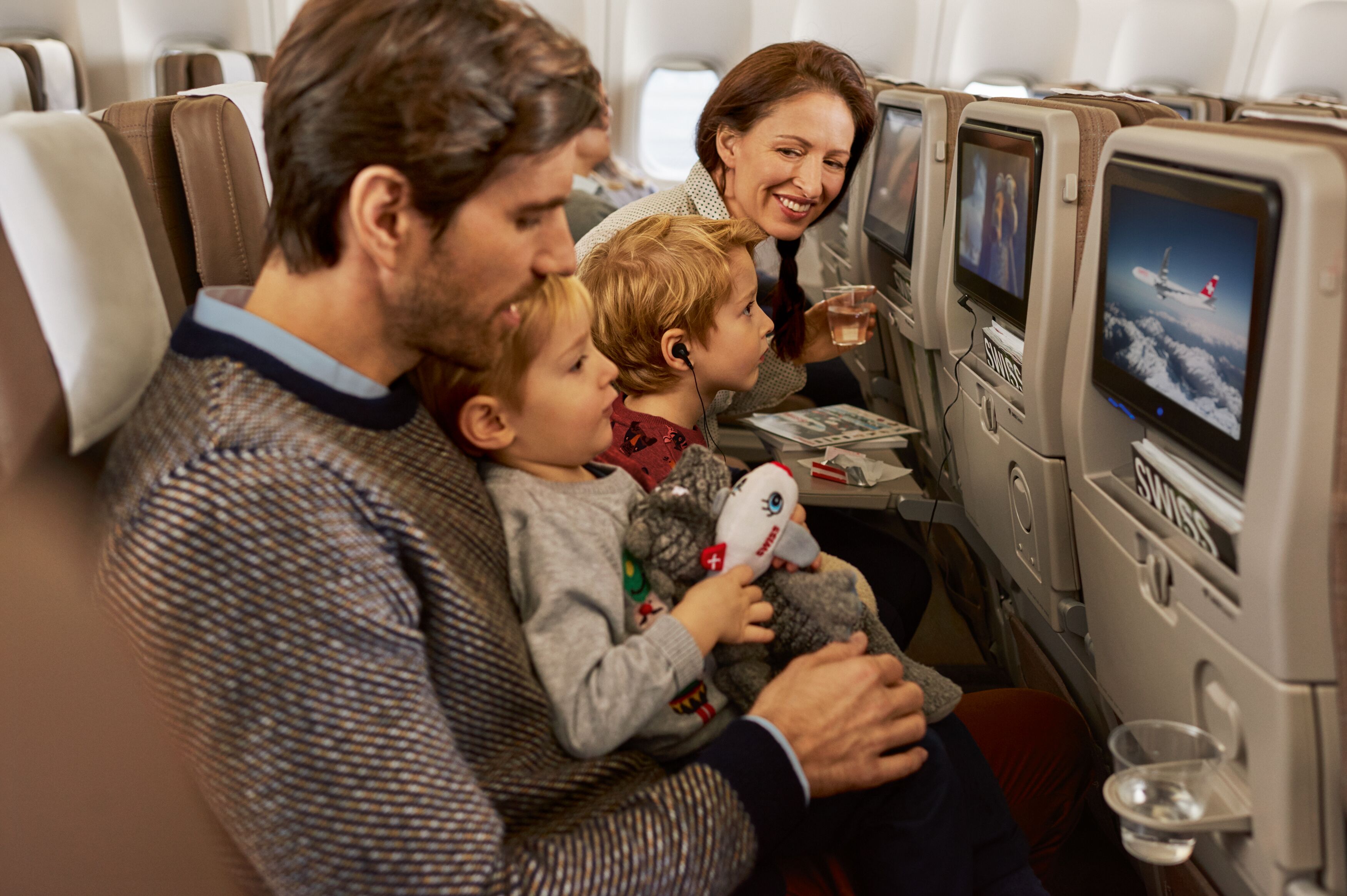 Familie sitzt in der Economy Class der Boeing 777 der Swiss Airline