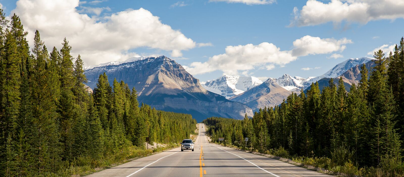 Ein Auto fährt auf dem Icefields Parkway im Jasper Nationalpark, Alberta
