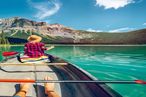 View of a young couple canoeing on beautiful mountain lake in Canada