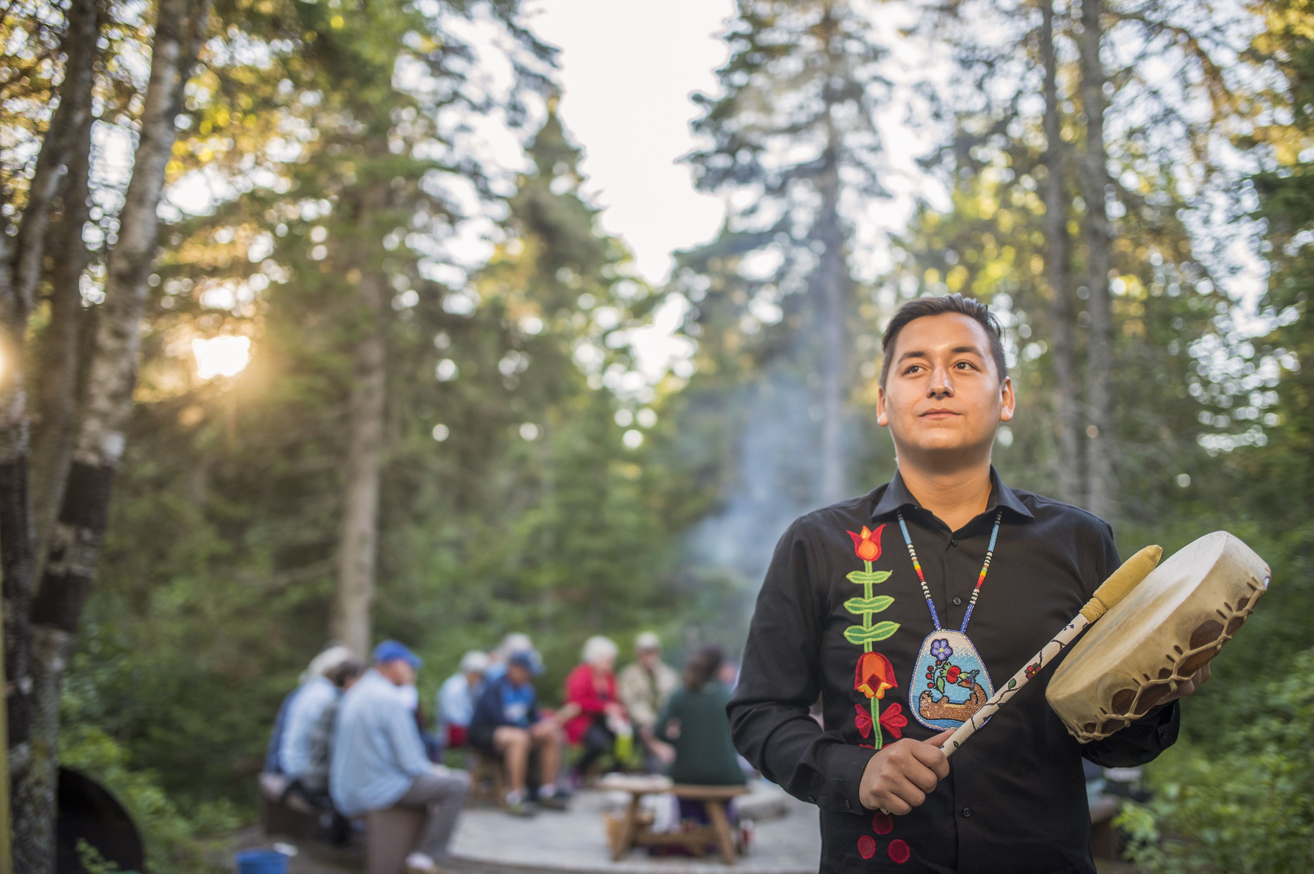 Besucher des Trommelkurses am Lagerfeuer im Pukaskwa National Park in Ontario