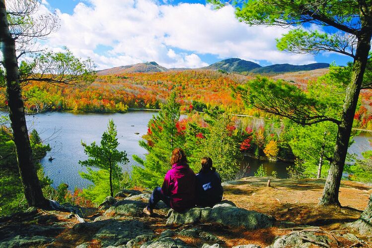 Zwei Frauen beobachten den Indian Summer in einem Park in Québec