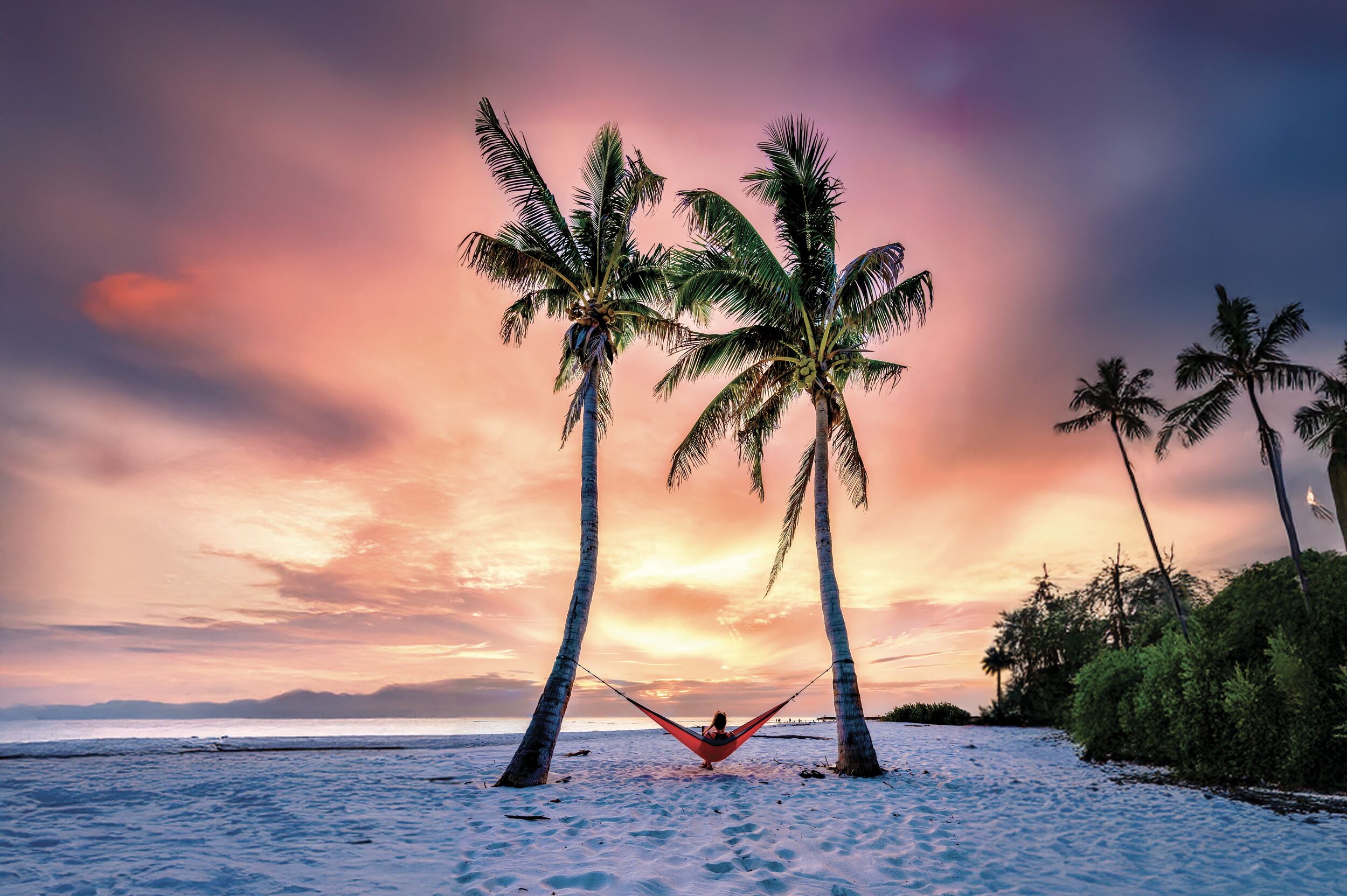 Auf einer Hängematte unter Palmen den Sonnenuntergang in Fort Myers genießen
