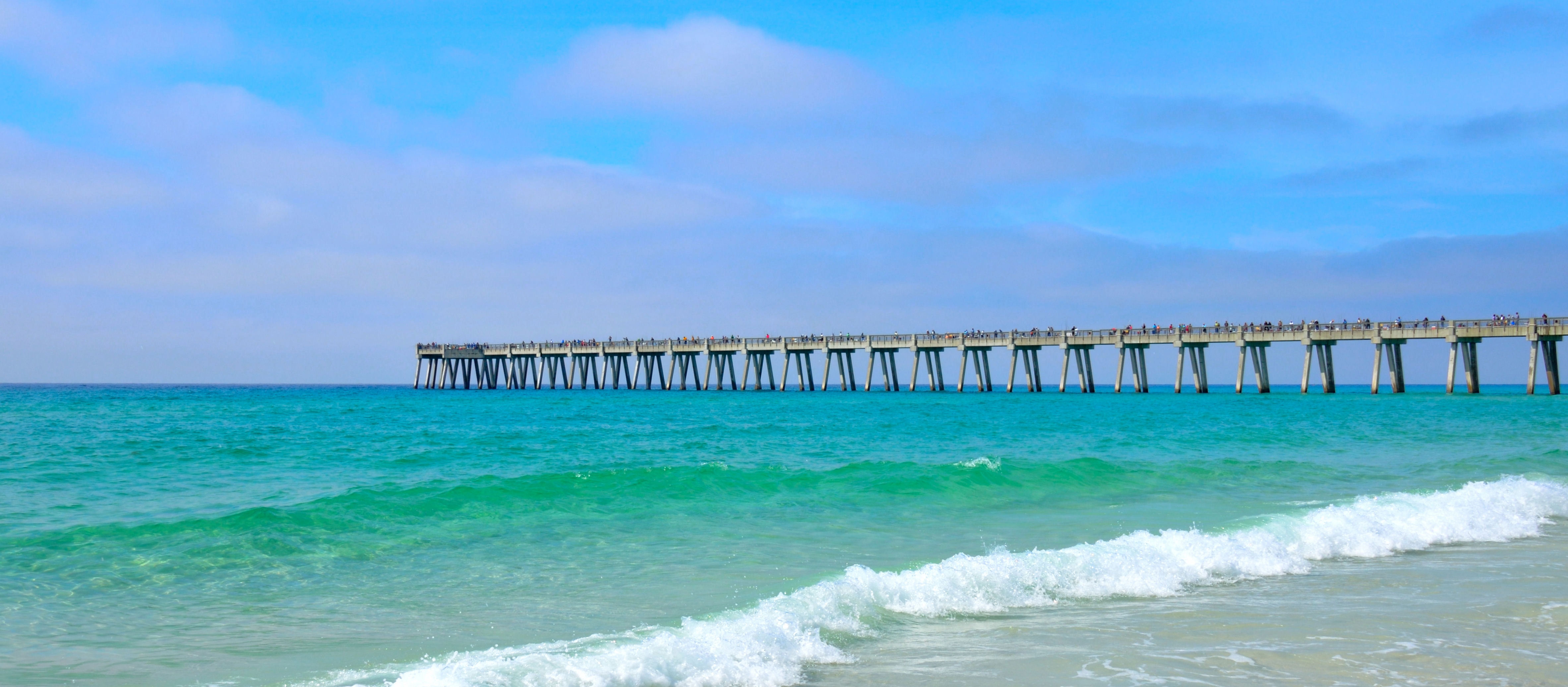Pier extending out over the blue green ocean at Panama City