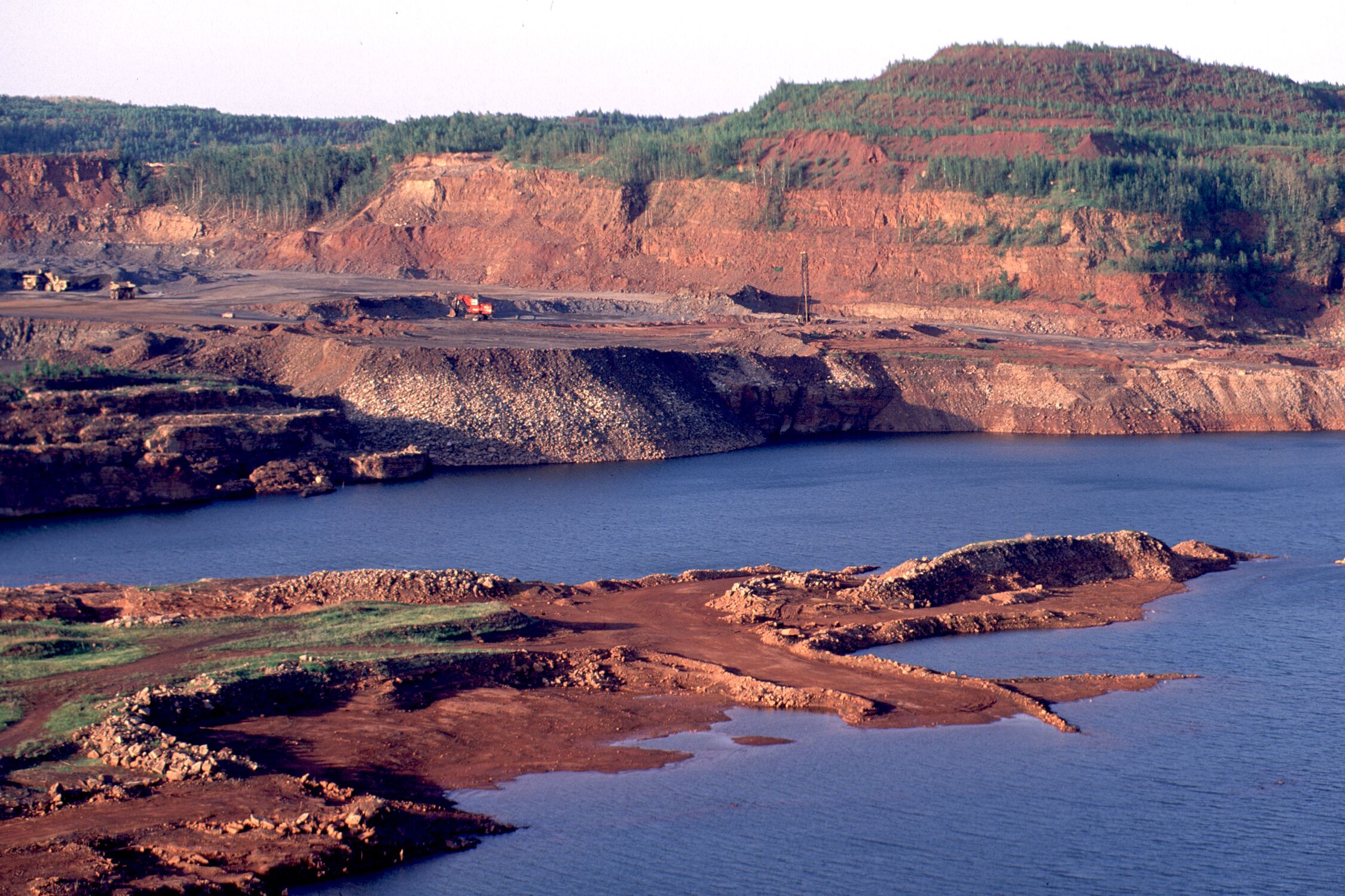 53. Hull Rust taconite open pit mine in Hibbing. The first of the Mesabi RangeÕs open-pit mines, and still engaged in taconite operations, is this 3-mile long pit. Observe the impressive current operations from the observation deck, on the north side of town.