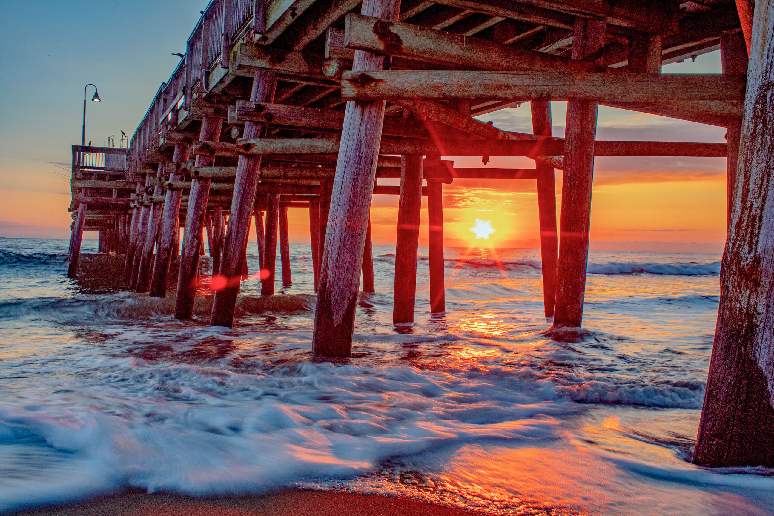 Goldener Sonnenaufgang am Sandbridge Fishing Pier am Virginia Beach in Florida
